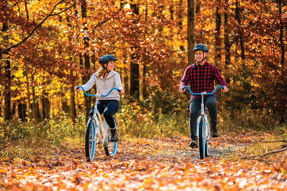 People riding bikes through the fall foliage at Canaan Valley Resort. Canaan Valley Resort is located in the Advantage Valley region of West Virginia.
