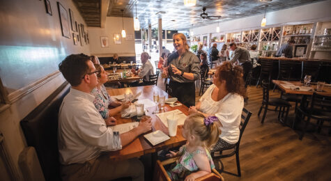 Taylor Perry serves Ray Harrell, left, and his mom Mimi at 1010 Bridge restaurant in Charleston, which is part of the Advantage Valley region of West Virginia.