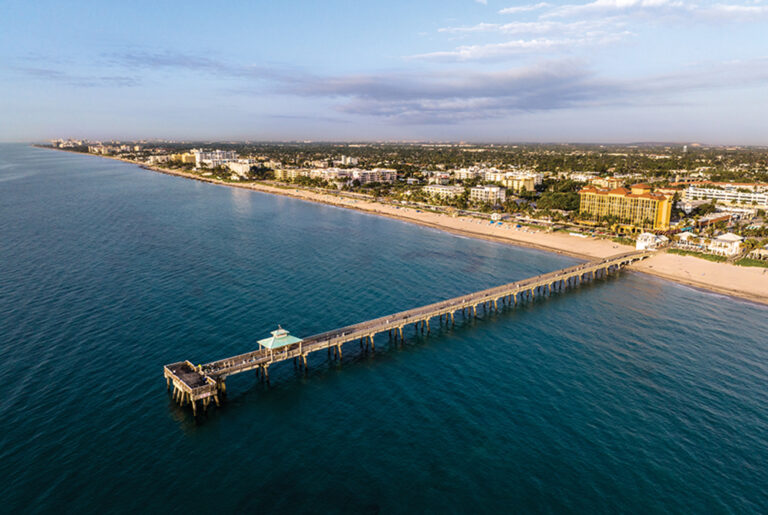 Sunrise over the pier in Deerfield Beach, Florida. Deerfield Beach is located in the Greater Fort Lauderdale region. Drone photo.
