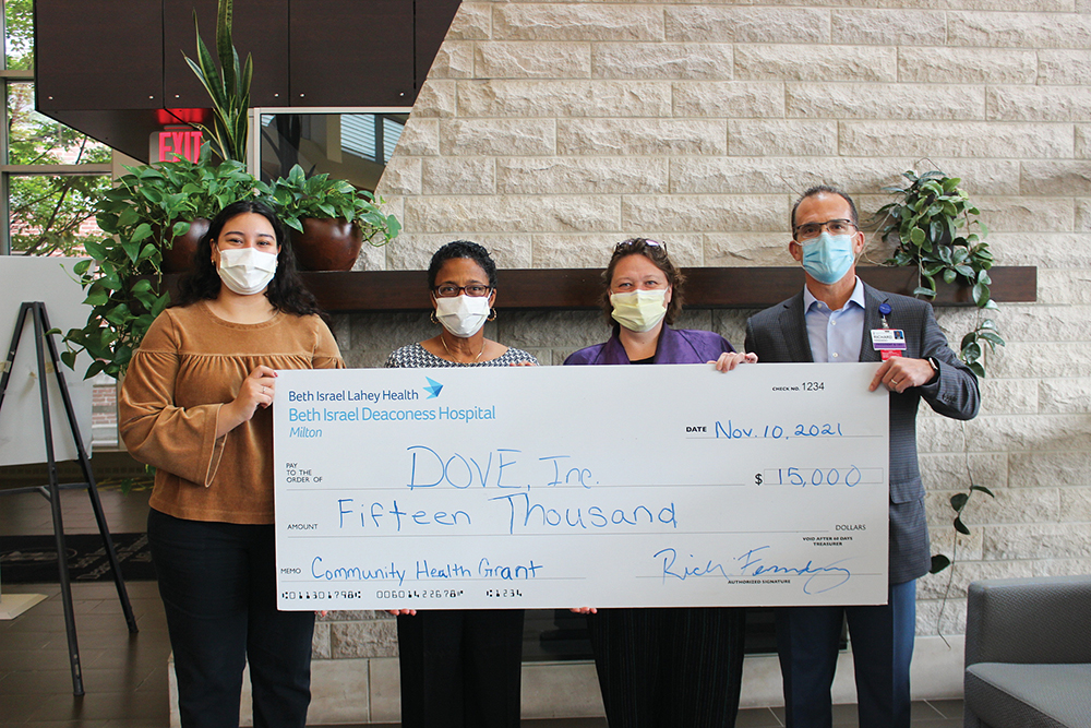 Community Health Benefits check presentation to DOVE Inc. Left to right: Sadie Blanco, DOVE communications and development associate, Dawn Hayes, director, DOVE marketing and philanthropy, Sue Chandler, executive director, DOVE, and Rich Fernandez, president, Beth Israel Deaconess Hospital-Milton stand with a check to donate to DOVE, Inc. at Beth Israel Deaconess Hospital-Milton in Quincy, MA.