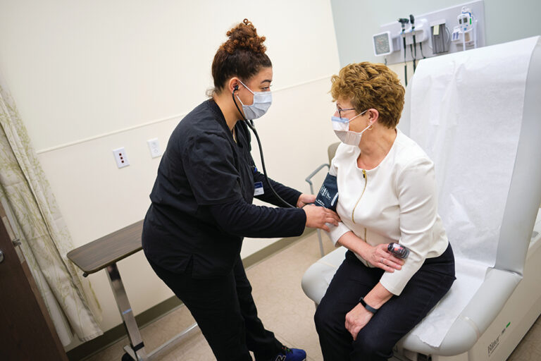 Nurse checks a woman's blood pressure at Courtesy of Beth Israel Deaconess Hospital-Milton, near Quincy, MA.