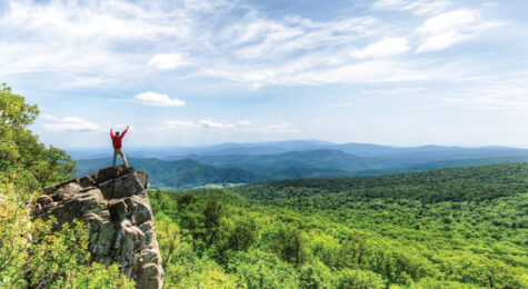 Person stands on top of a mountain at Shenandoah National Park, which is located in Central Virginia.