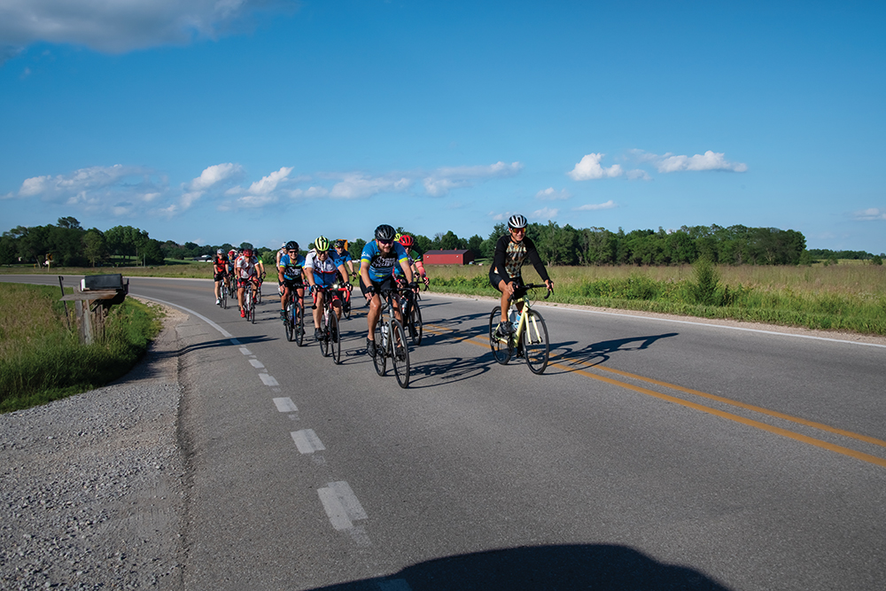 Group of Cedar Valley cyclists on the road.