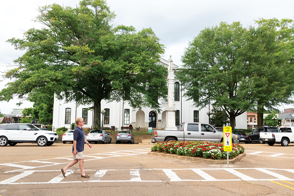 Scenes from Oxford, Mississippi: a man walking through the downtown square.