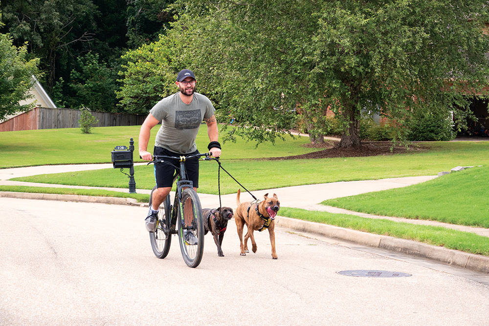 Scenes from Oxford, Mississippi - A man riding his bike with his dog.
