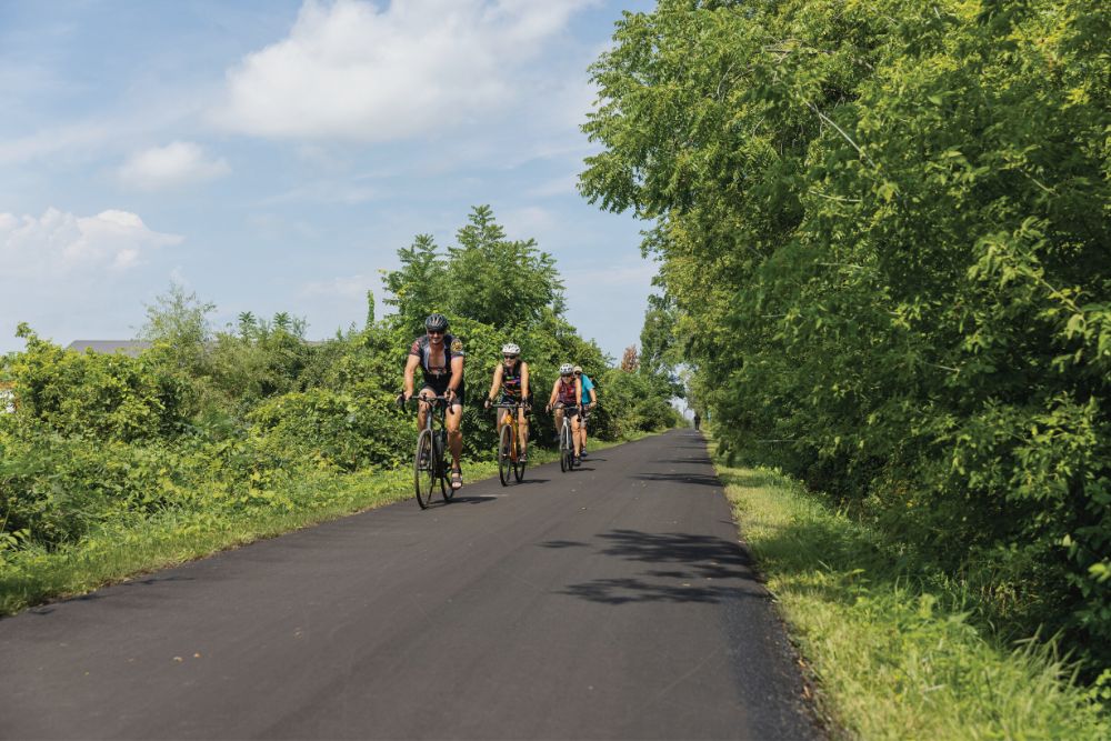 A group rides bicycles along the Cedar Valley Nature Trail in Cedar Rapids, Iowa.