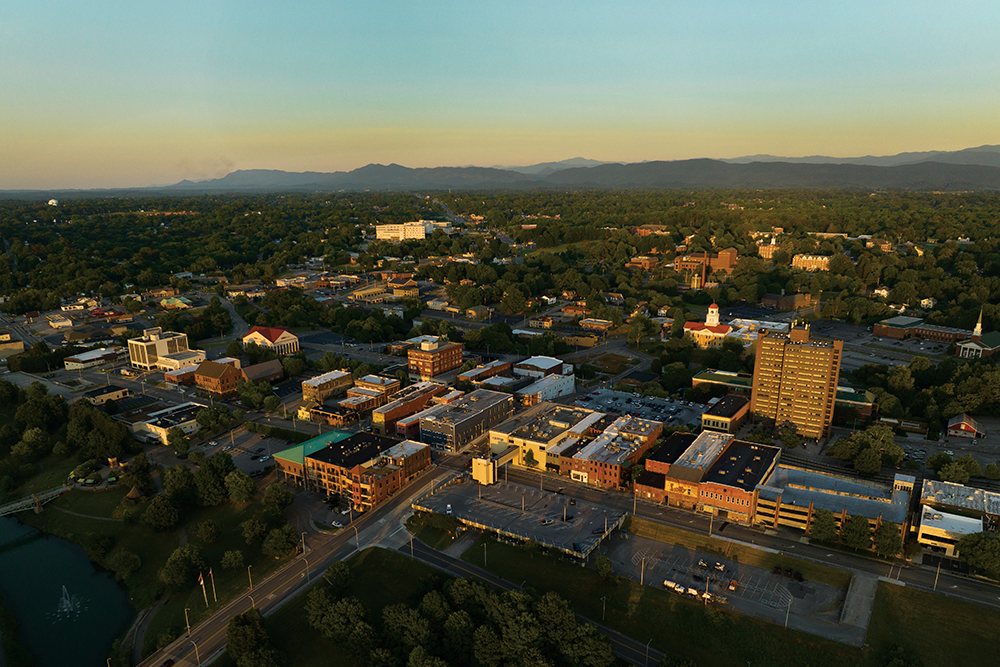 An aerial view of downtown Maryville, Tennessee, which is in Blount County, with a view of the Great Smoky Mountains in the distance. Drone photo.