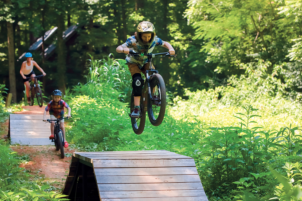 Joseph Carriker, 9, jumps a ramp on the Skills Course at Vee Hollow mountain bike trails in Townsend, Tennessee in Blount County.