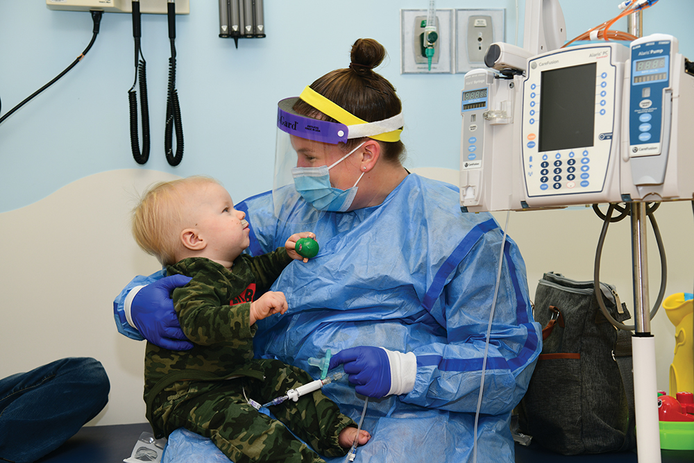 Nurse sits with a child at East Tennessee Children's Hospital in Knoxville, TN.