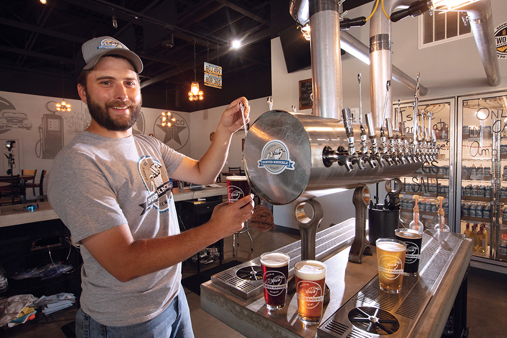Man serves up a beer at a brewery in Williston, ND.