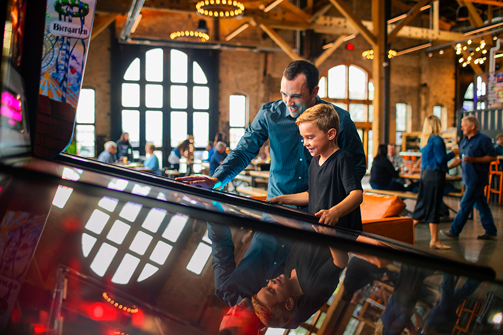 A father and son play arcade games at 13. Sip a craft brew at Drekker Brewing Company in North Dakota. 