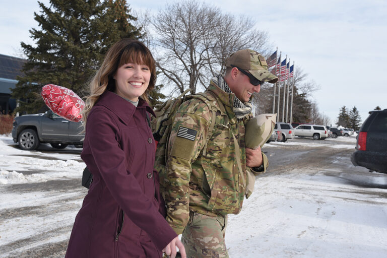 Staff Sgt. Zak Bergstrom, of the 119th Security Forces Squadron, North Dakota Air National Guard, walks to his car with his wife as she greets him at Hector International Airport, Fargo, N.D., upon his return home from a six-month deployment to southwest Asia Jan. 18, 2018. (U.S. Air National Guard photo by Senior Master Sgt. David H. Lipp) Credit North Dakota National Guard