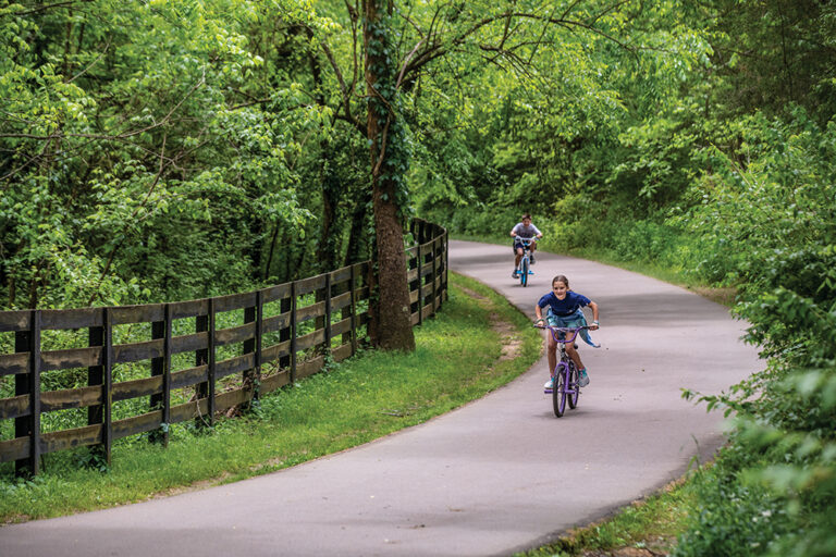 Children ride their bike along the trail at River Park in Brentwood in Williamson County.