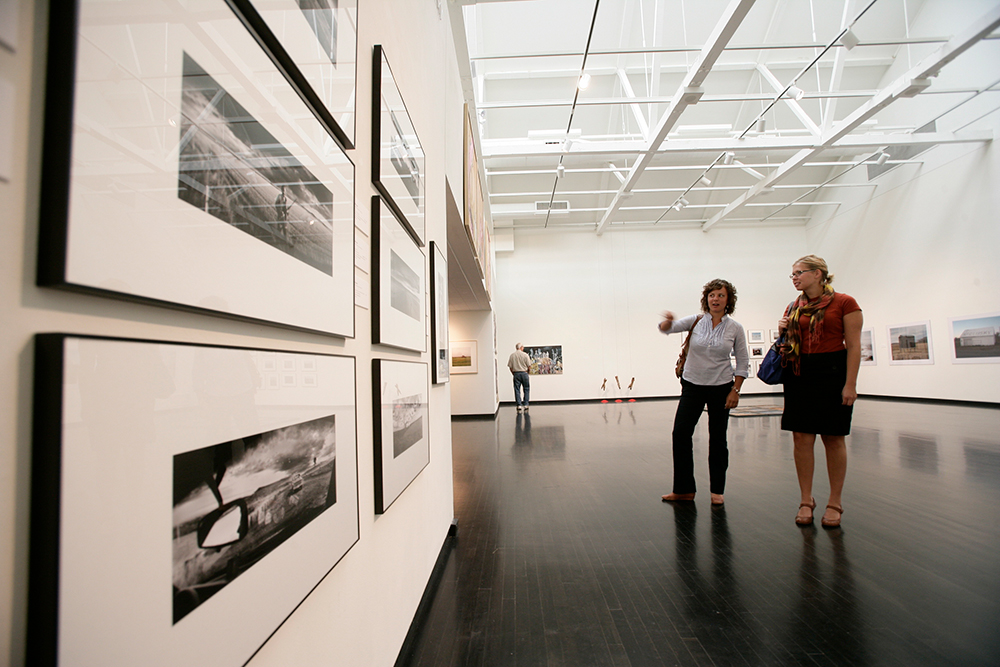 People enjoy a gallery in Grand Forks, ND. 