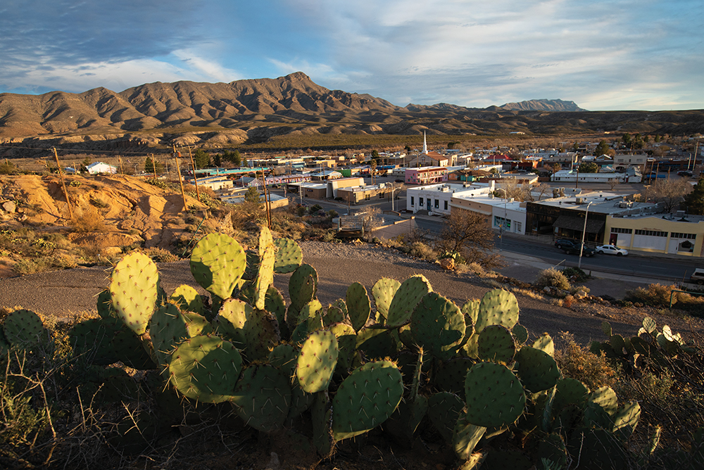 The setting sun illuminates the cacti and Caballo Mountains surrounding Truth or Consequences, New Mexico.
