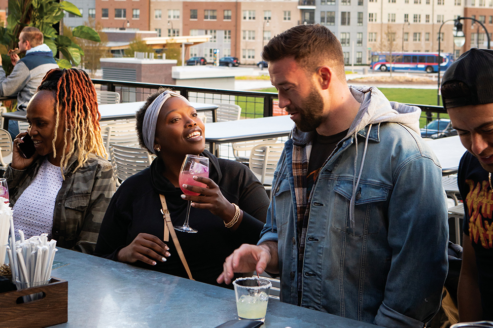 Wacuga Nganga, left, and Kevin March talk while at the outdoor bar at The Mercantile in Worcester, MA.