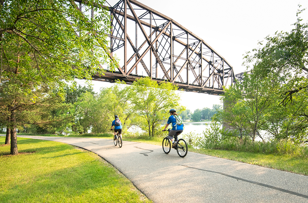 Duo rides their bikes along the Mandan Rail Bridge Trail in Pioneer Park, which is located in Bismarck, ND. 