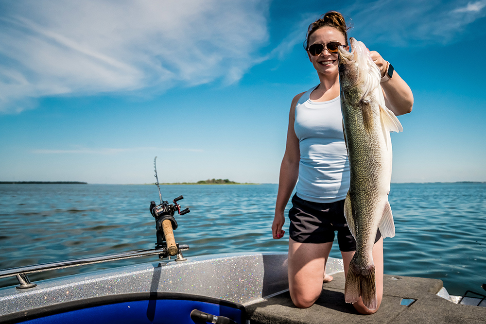 Woman holds up a fish that she caught at Devil's Lake in North Dakota.