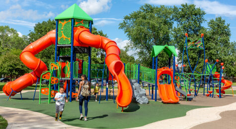Families play at Hessel Park Playground in Champaign County, Illinois. The Champaign-Urbana region is family-friendly.
