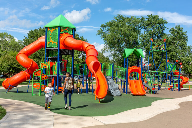 Families play at Hessel Park Playground in Champaign County, Illinois. The Champaign-Urbana region is family-friendly.