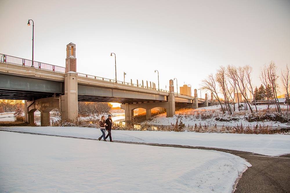 People walk along the banks of the Red River in Fargo, ND, during the winter. Free to use and share; Credit "Visit Fargo-Moorhead"
