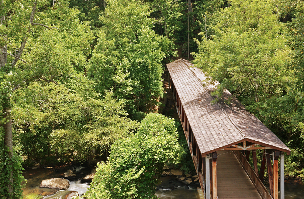 This covered bridge in Georgia is a pedestrian bridge that crosses Big Creek (once known as Vickery Creek) in the city of Roswell.