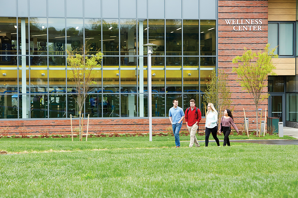 Students walk outside of the Wellness Center at Worcester State University in Worcester, MA.