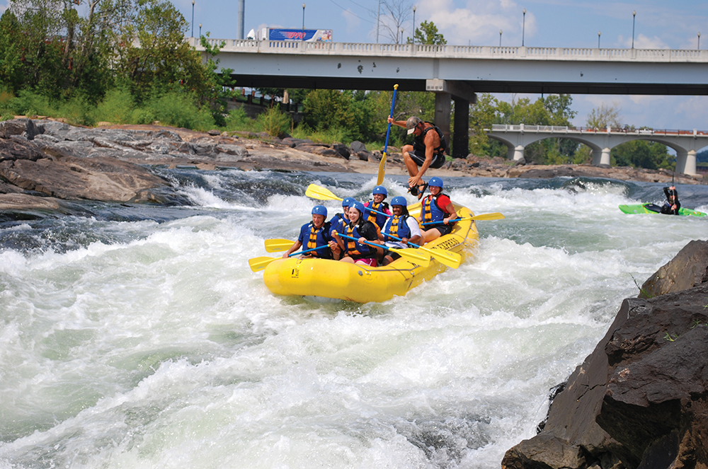 Group whitewater rafting in Columbus, GA, where visitors can navigate the Chattahoochee River's Class I to Class V rapids on the world’s longest urban whitewater course in the world.