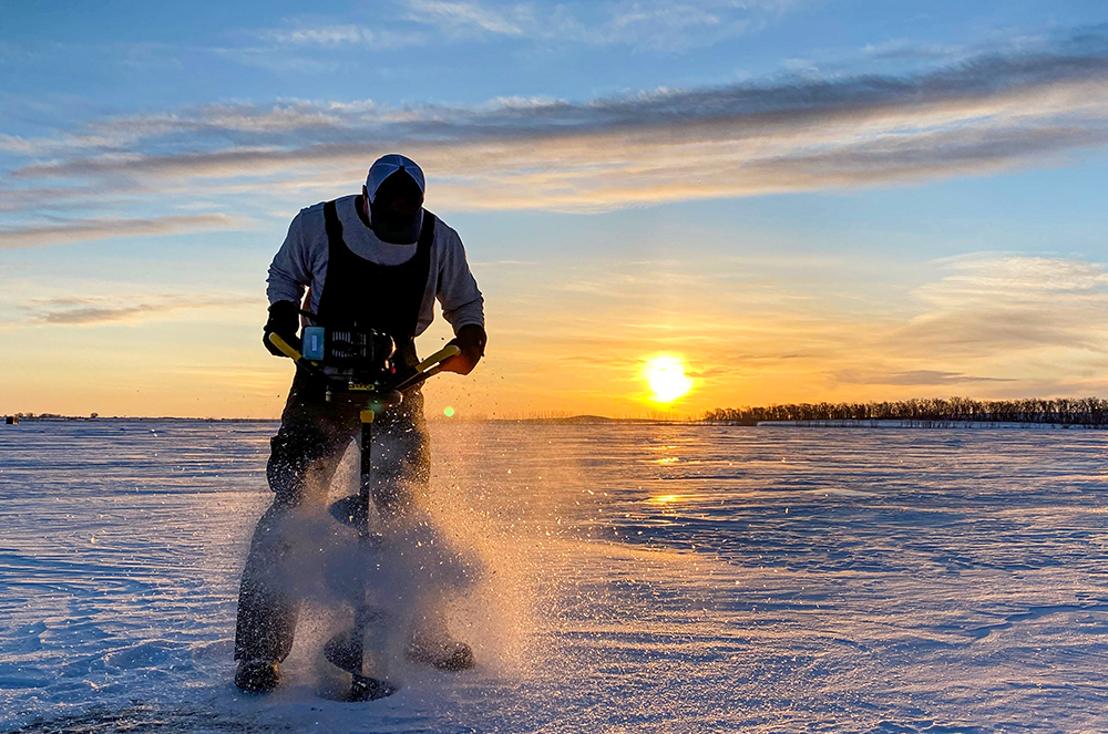 Silhouette of a man ice fishing in North Dakota. 