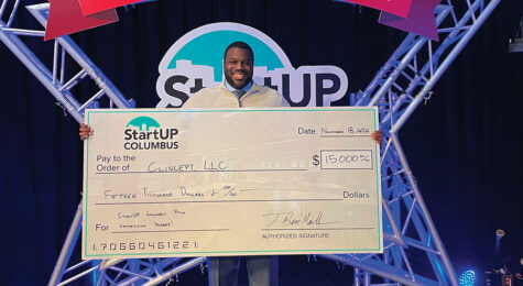 Jay Pitts, president and CEO of ClinCept, holds the winning check at the 2021 Pitch Competition.