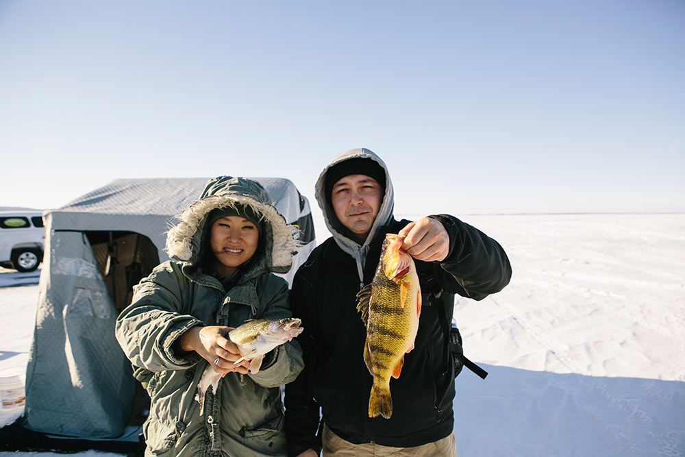 People pose with a fresh catch from an ice fishing excursion in North Dakota.