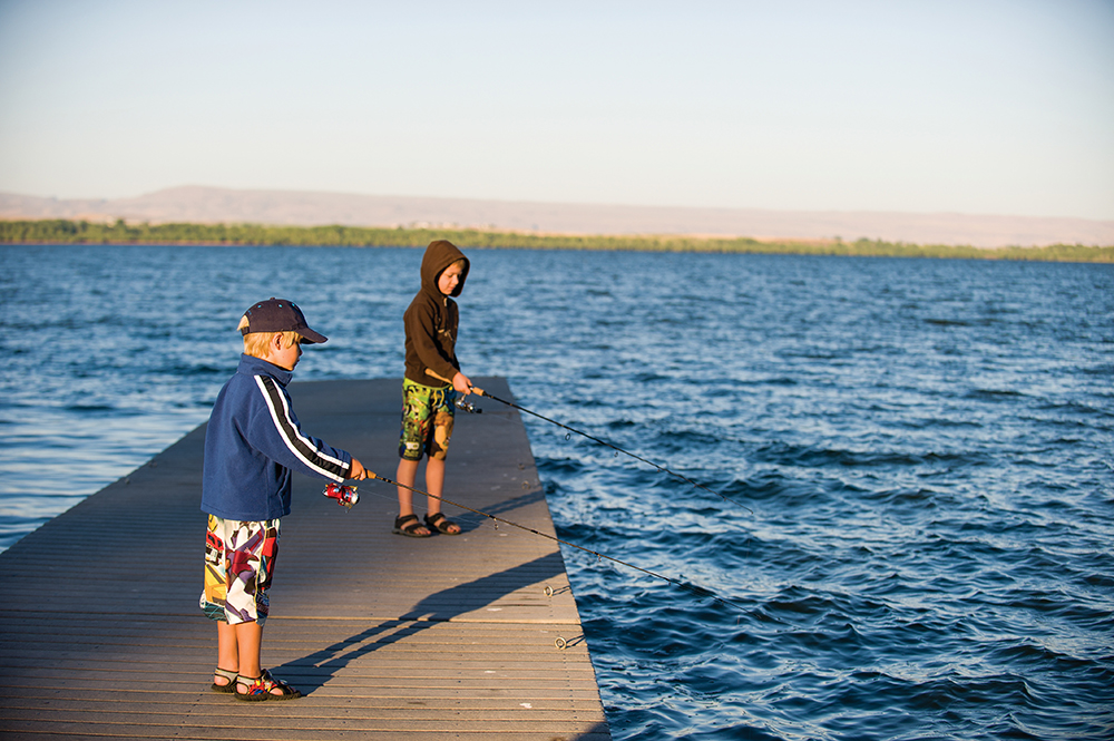 Children fishing off of a pier in Nampa, Idaho.