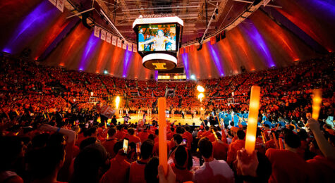 Glow sticks and plenty of Illini pride light up State Farm Center as members of the Orange Krush cheer on the University of Illinois men's basketball team. The work of the Orange Krush does more than just help the team on the court. As a branch of the registered student organization, Illini Pride, at the University of Illinois at UrbanañChampaign, Orange Krush members fund raise, donating more than $2 million to help local and national charities.