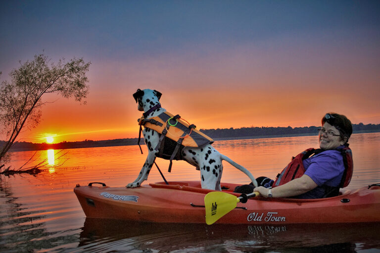 A man kayaks with his dog in New Castle, Indiana.