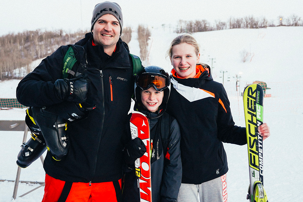 Family in ski gear poses in North Dakota after hitting the slopes. 