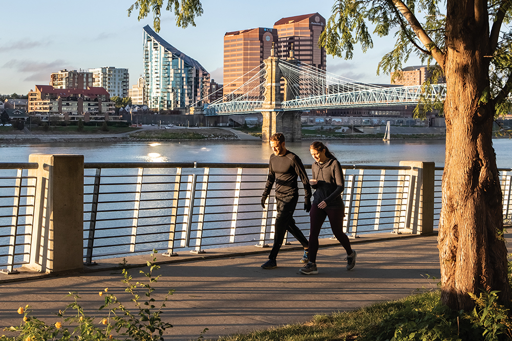 People exercise at the Smale Riverfront Park as the sunrises on downtown Covington across the Ohio River. Covington is located in the Northern Kentucky region.