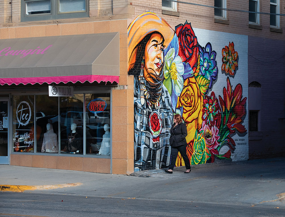 A visitor walks past a colorful mural in downtown Casper, Wyoming