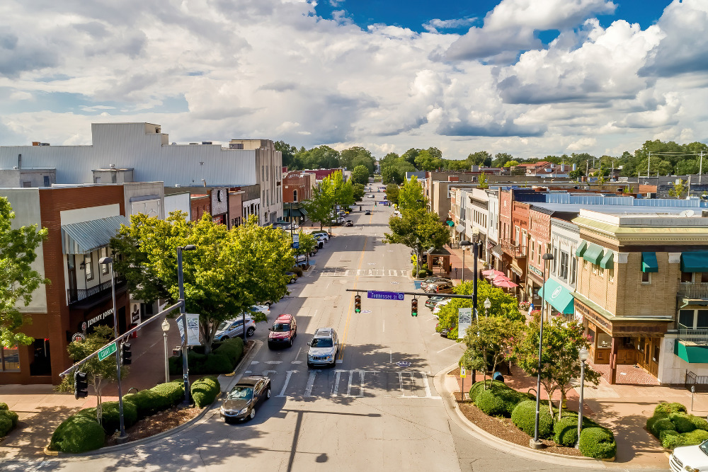 Aerial shot of downtown Florence, Alabama, on a sunny day. Shops line the streets and residents can live the good life as Florence is one of the cities least impacted by inflation.
