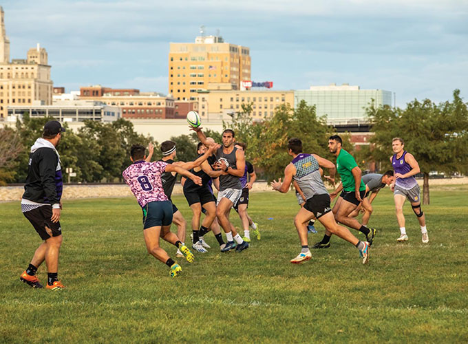 A rugby team practices at Centennial Park in downtown Davenport, IA. As one of the best places to live in the U.S., Davenport offers great museums, trails for walking and biking, and a fun food scene with craft breweries and food trucks.