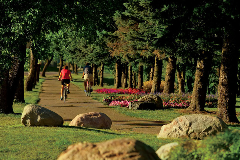 A biking path in downtown Fargo, ND, winds through acres of pine forest. Fargo's affordability and quality of life make it one of the best places to live in the U.S.