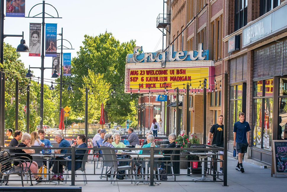 Shops and restaurants line the sidewalk next to the Englert Theatre in Iowa City, IA, one of the best places to live in the U.S.