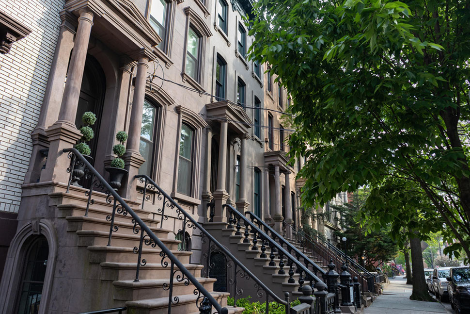 A row of beautiful old brownstone homes in Jersey City, NJ. Walkable neighborhoods, outdoor concerts and an eclectic food scene help make Jersey City one of the best places to live in the U.S.