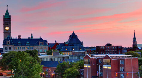 An aerial view of downtown Lowell, MA. Lowell has a thriving arts scene, cobblestone streets, and a bustling downtown.