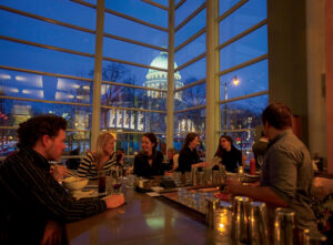 Guests enjoy a view of the state capitol building at dusk while dining at Graze Restaurant in downtown Madison, WI, one of the best places to live in the U.S. in 2023.