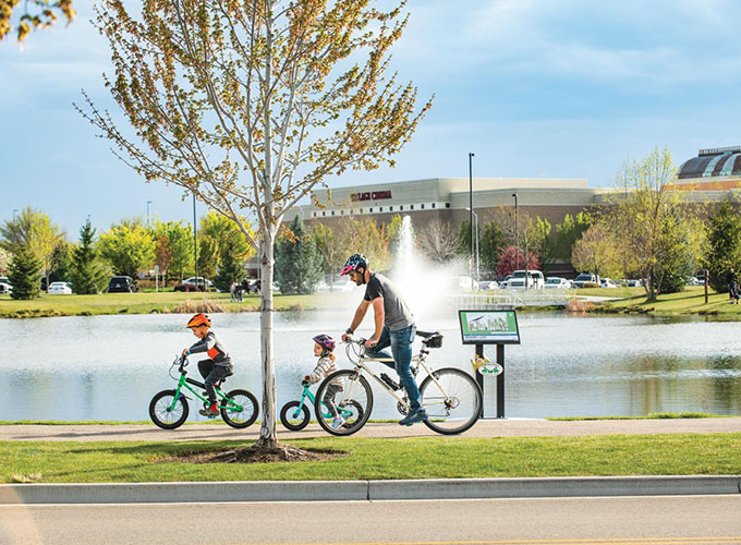 A family bikes in Julius M. Kleiner Memorial Park in Meridian, ID. A suburb of Boise, Meridian has all the advantages of city life plus beautiful surroundings and plenty of outdoor activities.