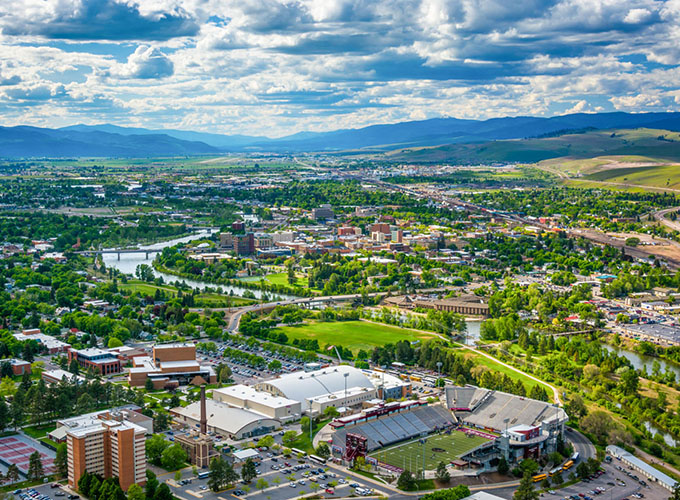 An aerial view of Missoula, MT. Located in the Northern Rockies, Missoula offers world-class outdoor recreation as well as an impressive arts and culture scene while retaining a small-town feel, making it one of the best places to live in the U.S.