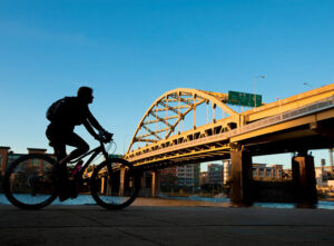 A man bicycles on a greenway in downtown Pittsburgh, PA, consistently ranked one of the best places to live in the U.S.