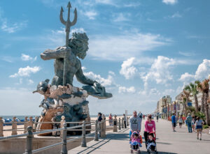 A giant statue of King Neptune presides over an oceanfront park in Virginia Beach, VA. The city attracts thousands of visitors a year, but its many amenities also make it one of the best places to live in the U.S.