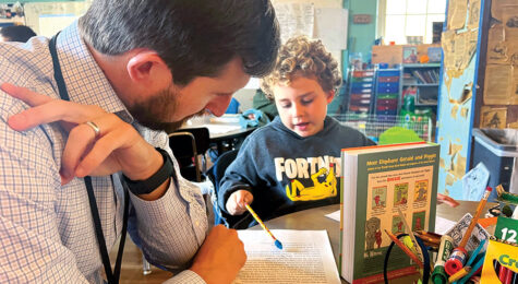 James Sullivan, Director of Rutherford County Schools, works with an elementary-age student.