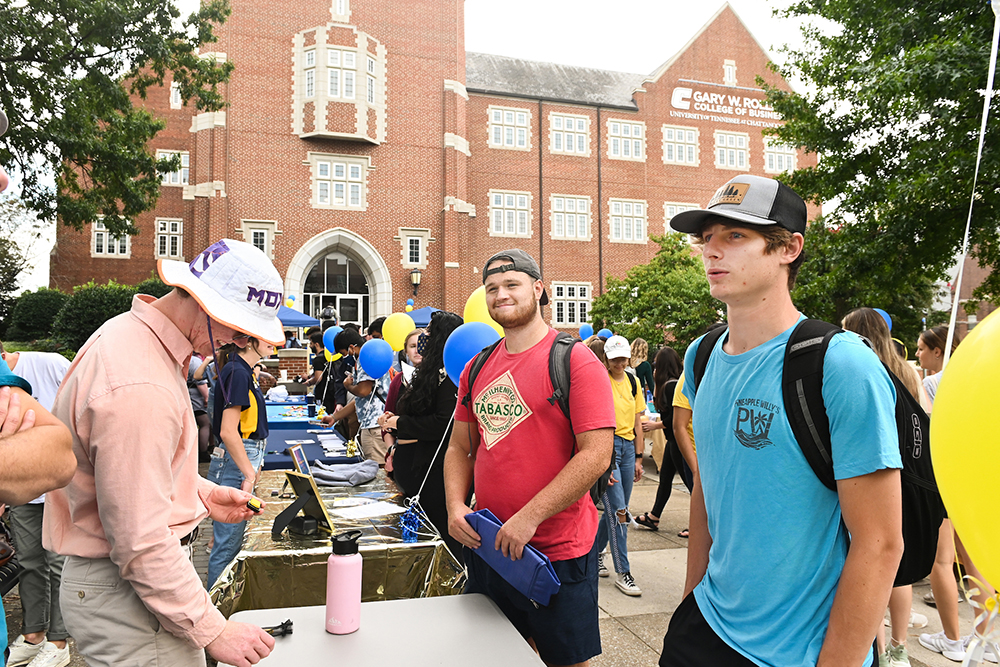 Students attend Rollins Day, a fair for prospective students, outside the Rollins College of Business.